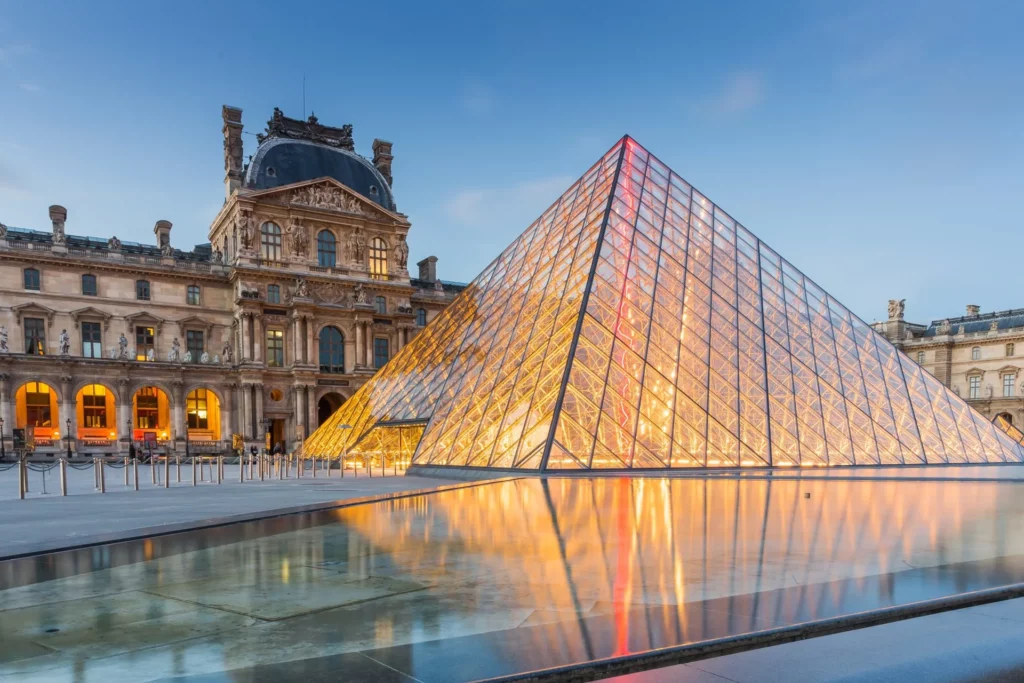 A captivating view of the Louvre Museum's glass pyramid surrounded by historic architecture.