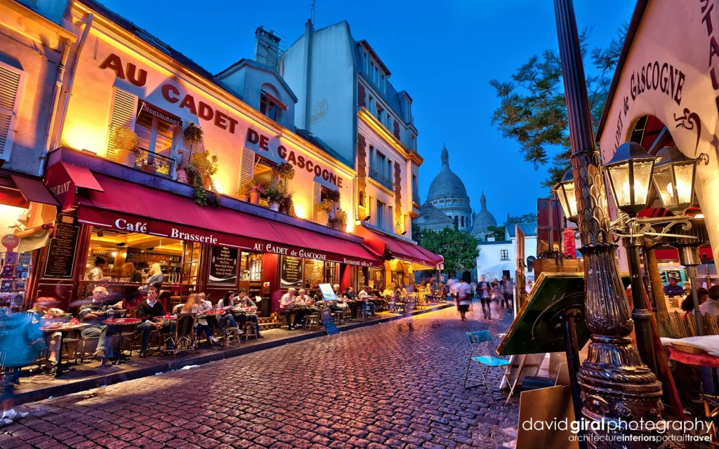 A picturesque view of Montmartre's quaint streets, with the famous Sacré-Cœur Basilica standing tall in the background.