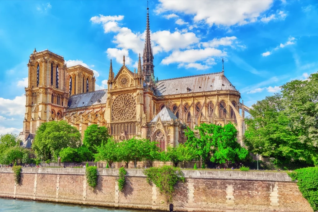 An enchanting view of Notre-Dame Cathedral's intricate facade against the backdrop of a clear blue sky