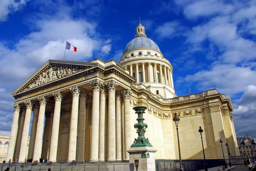 A majestic view of the Panthéon's impressive facade, showcasing its neoclassical architecture and iconic dome.
