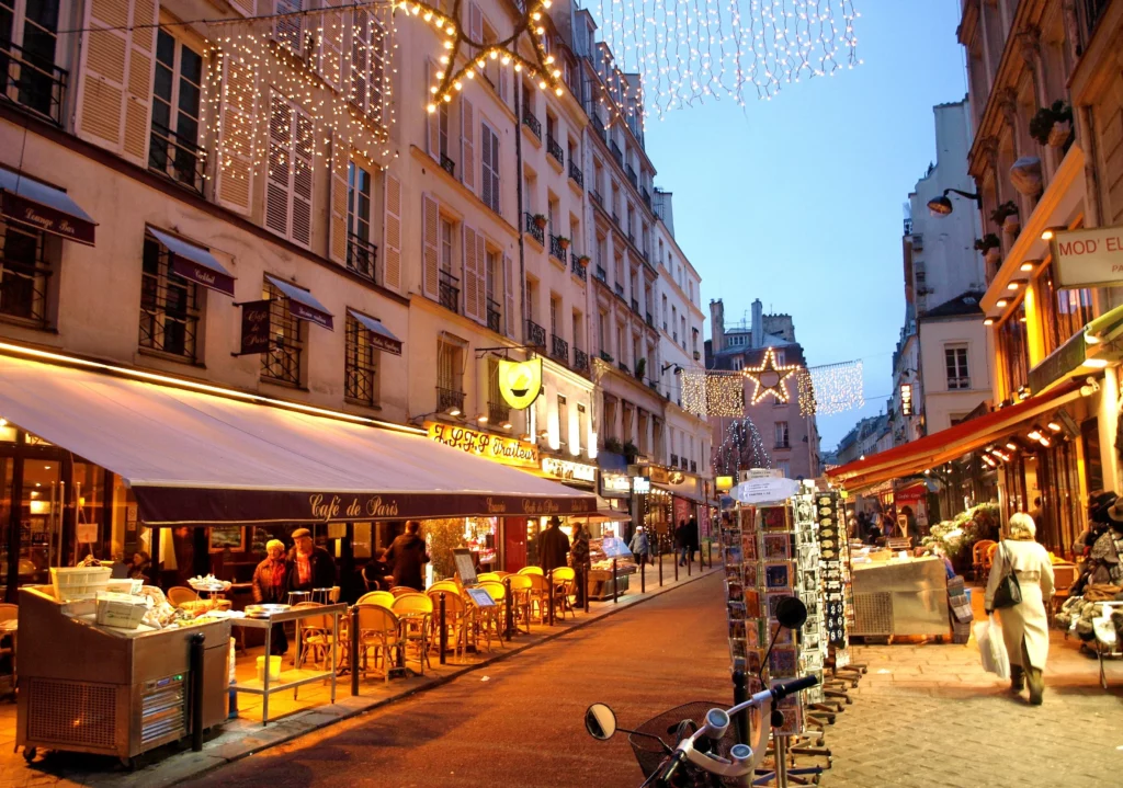 A charming street in the Latin Quarter of Paris, lined with historic buildings, cafes, and bookshops.